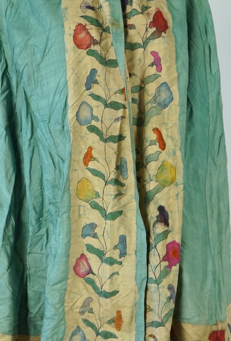 A 1920’s light green silk evening cape with hand batik borders and label: Tito de Canival Mode, together with a navy ladies two piece suit and a maroon satin evening dress. Cape 100cm long. Condition - cape good, navy tw